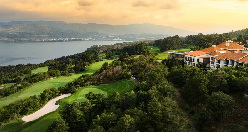 Golf fairway framed by cherry blossoms and mountains, China Golf fairway framed by cherry blossoms and mountains, China