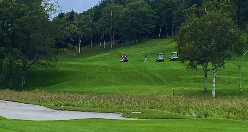 Summer Golf in Hokkaido - Hokkaido Brooks Golfers and carts on the fairway at Hokkaido Brooks Golf Club during summer