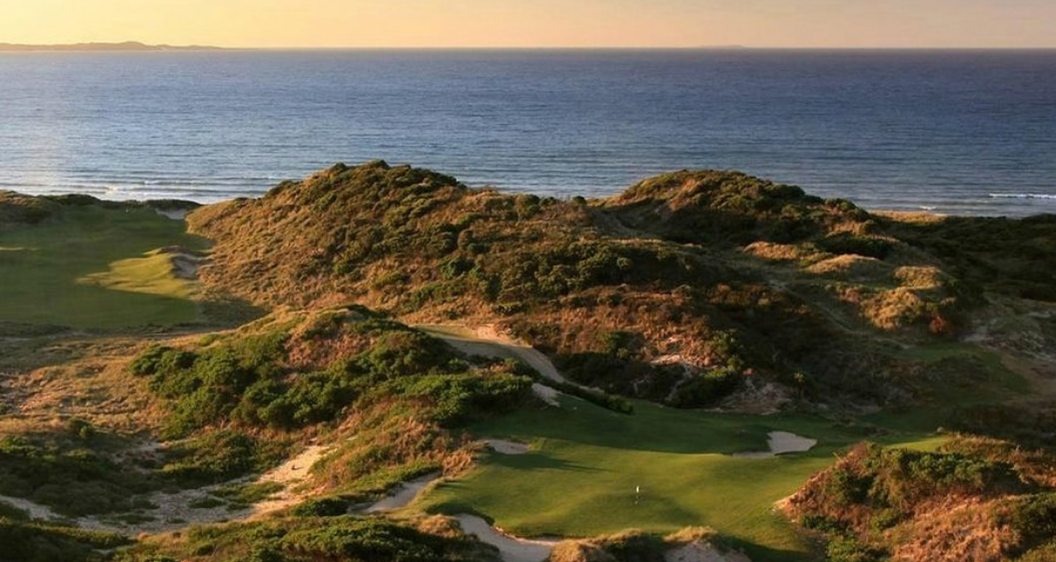 Illustrative Tasmanian links golf course with rolling fairways, coastal dunes and a winding tidal inlet for the Barnbougle Lost Farm section.